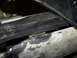 1990 Ford Bronco - This photo shows a close-up view of metalwork and trim on a vehicle's undercarriage.