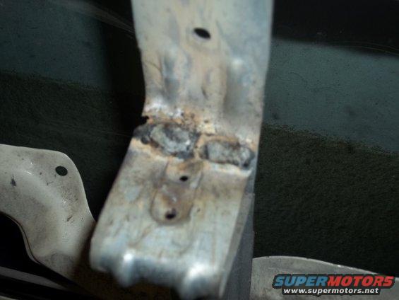 Welded metal bracket with holes and rust. Supermotors.net logo visible
