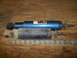 1990 Ford Bronco - Two shock absorbers, one blue and one black, are shown with a ruler for size comparison.