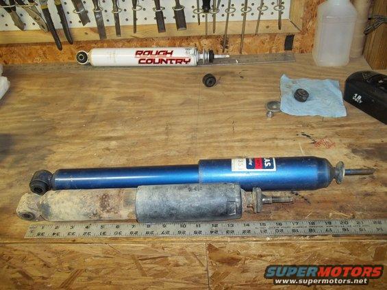 Rough Country shock absorber and a blue shock absorber with a ruler for scale