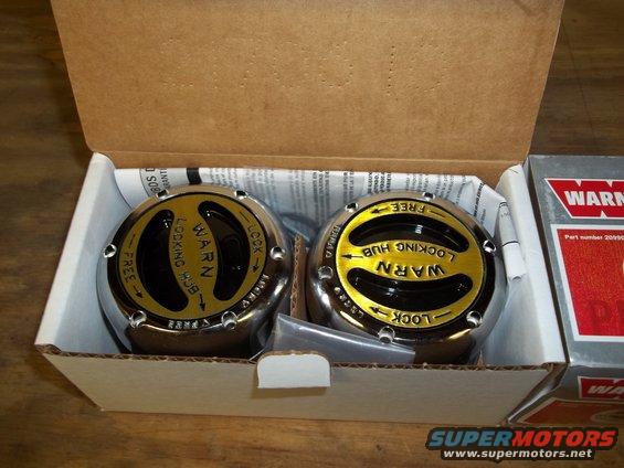Pair of Warn locking hubs, chrome and gold, in cardboard box