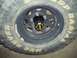 1990 Ford Bronco - Close-up of a wheel and tire assembly, likely from an off-road vehicle.