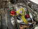 1990 Ford Bronco - Close-up view of an engine's ignition system, a red MSD distributor and yellow spark plug wires.