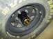 1990 Ford Bronco - A close-up view of a vehicle's wheel, a black hubcap and tire with yellow lettering.