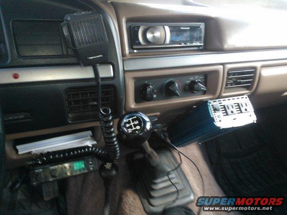 Interior view of a vehicle with a Realistic CB radio, Pioneer stereo, and aftermarket amplifier
