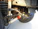 1992 Ford Bronco - The underside of a vehicle shows its suspension system, including shocks and springs.