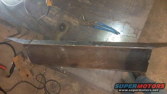 Metal fabrication project with welding equipment and tools on concrete floor