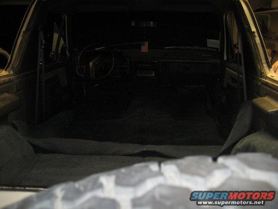 1989 Ford Bronco interior showing dashboard, steering wheel, and carpeted rear