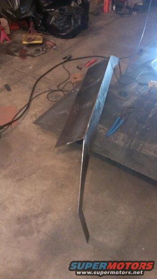 Metal part with sharp angles on a workshop floor