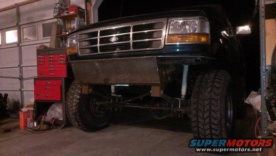 1995 Ford Bronco front end with custom metal bumper installed, showing grille and headlights