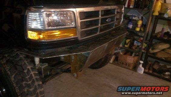 Black Ford Bronco front end with custom metal bumper, showing grille and headlight
