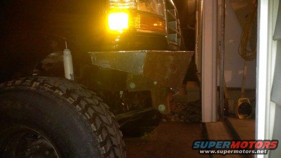 Custom metal front bumper on a 1992 Ford Bronco, with a large tire in the foreground