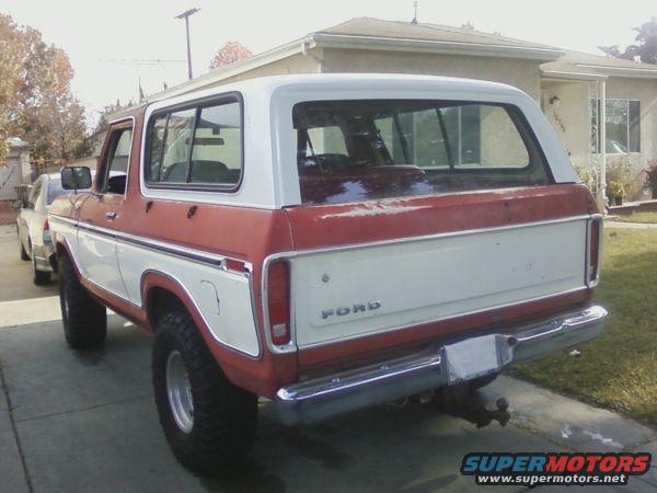 Rear view of a red and white 1978 Ford Bronco parked on a driveway