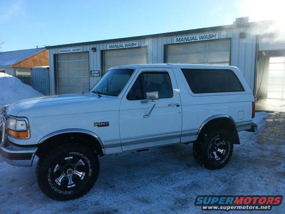 White 1994 Ford Bronco parked outside a manual car wash