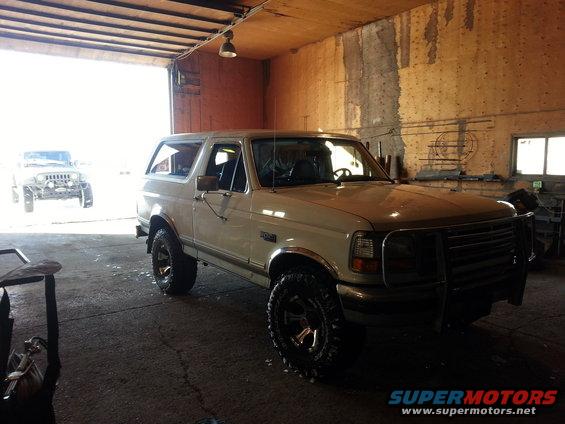 White 1994 Ford Bronco with bull bar and aftermarket wheels