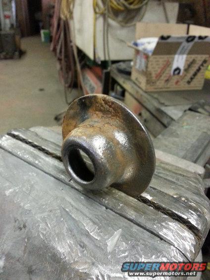 rusted metal part clamped in a vise