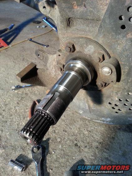 splined front axle shaft with tools on floor
