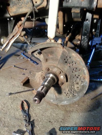 Vehicle's front wheel hub and brake rotor assembly, with tools scattered around