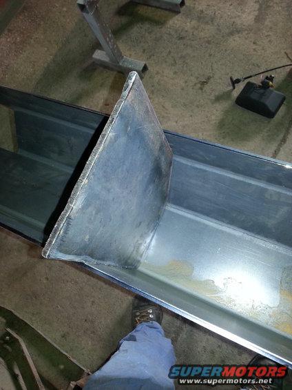 Metal channel with a triangular metal plate welded inside, viewed from above