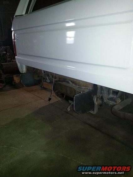 White 1994 Ford Bronco rear bumper area with exposed frame and wiring