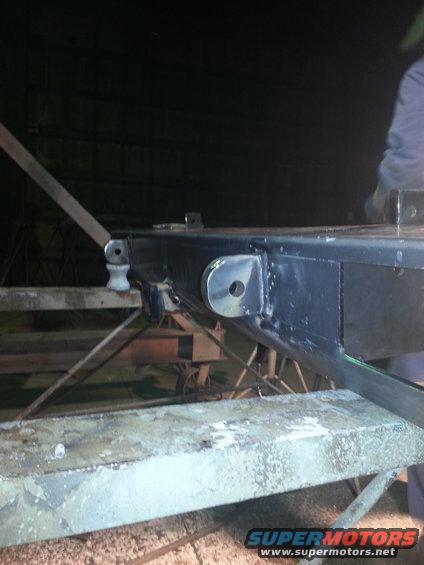 Close-up of vehicle frame with metal brackets and suspension components