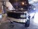 1992 Ford Bronco - The front end of a Ford Bronco is prepped for paintwork in a garage setting.