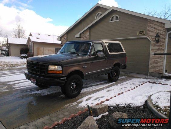 Brown 1992 Ford Bronco parked in driveway with snow