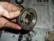 1990 Ford Bronco - Close-up of a wheel bearing lock nut, likely removed during maintenance or repair.