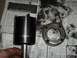1990 Ford Bronco - A black socket wrench part and a bearing are placed on a newspaper.