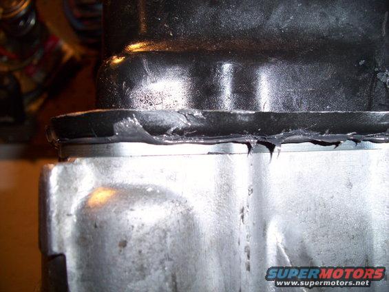 Engine part with black gasket material squeezed out