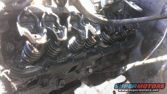 Close-up of engine valve train with oil buildup