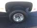 2008 GMC Sierra 3500 - Close-up of the rear dual wheels on a white GMC truck, showing the chrome hubcap and tire details.