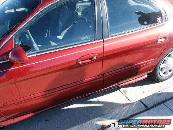 side view of a red sedan's front door and rear door
