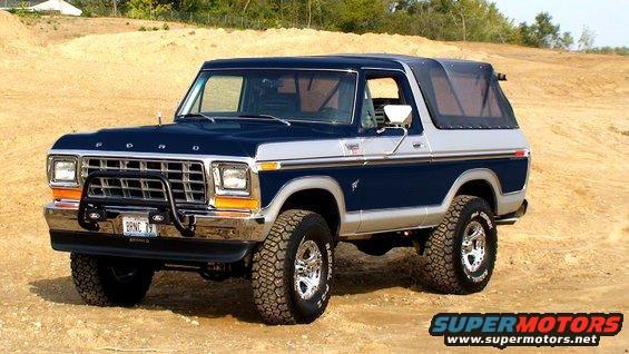 Blue and silver 1980-1986 Ford Bronco with aftermarket bumper and soft top