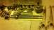 1996 Ford Bronco - Various drivetrain and suspension parts are laid out on the floor, including axles and a differential.