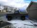 1992 Ford Bronco - This Ford Bronco is parked in a residential driveway during winter, custom blue exterior accessories.