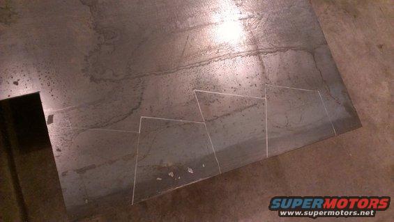 Metal sheet with chalk lines indicating a stepped pattern for cutting
