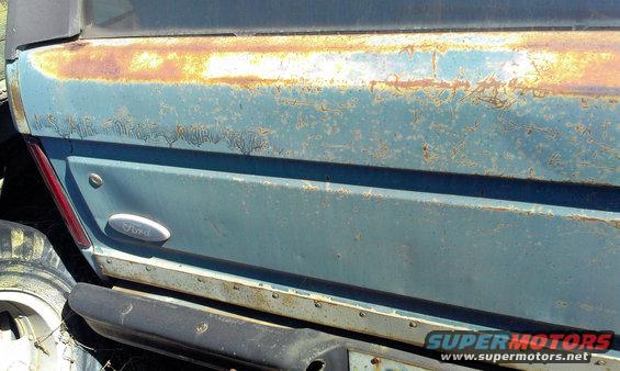 Blue Ford Bronco rear quarter panel with rust and "US AIR FORCE" text