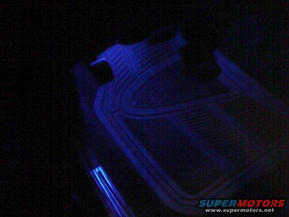 Car floor mats with blue LED lighting strips underneath