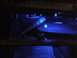 2003 Ford Crown Victoria - The dashboard of a 2003 Ford Crown Victoria is illuminated with blue light, revealing the steering wheel and instrument panel.