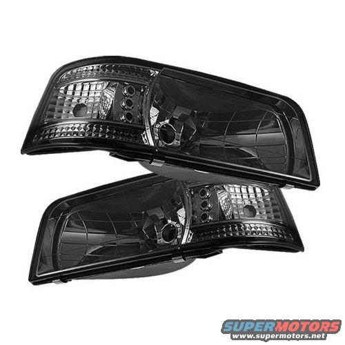 Pair of black aftermarket headlights with clear lenses and LED accents