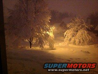 Snowy scene with illuminated trees and a "SUPERMOTORS" watermark