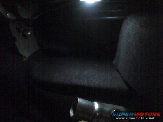 Interior view of a car with a metal pipe in the foreground