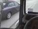 2003 Ford Crown Victoria - A dark sedan is seen from the perspective of a driver on a road.