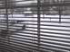2003 Ford Crown Victoria - A white pickup truck is visible through blinds on a snowy day.