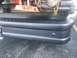 1992 Ford Bronco - Close-up of a vehicle's rear bumper, showing a step and tow hitch chains.