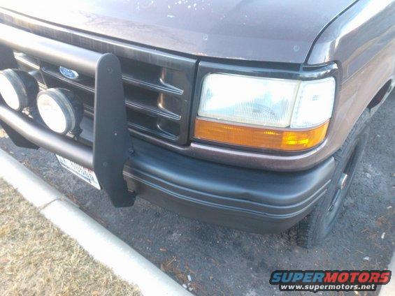 Brown SUV front with bull bar and fog lights. 1992 Ford Bronco