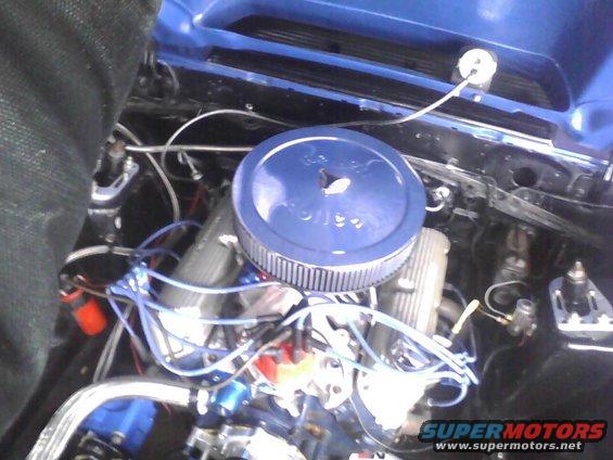 Engine bay showing air cleaner, distributor, and wiring