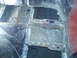 1978 Ford Bronco - Close-up view of a heavily rusted and damaged vehicle floor pan, showing signs of repair.