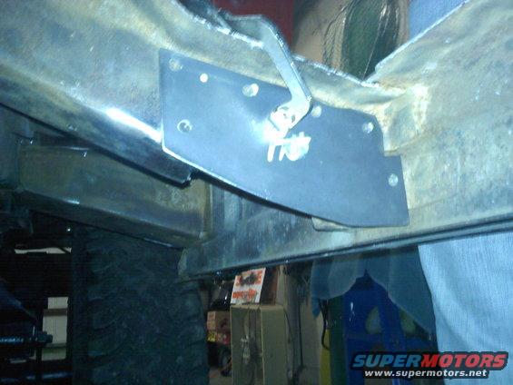 Underbody chassis modification plate with visible text